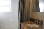 Bathroom has matching granite counter top as the kitchen and also has a tub and shower 